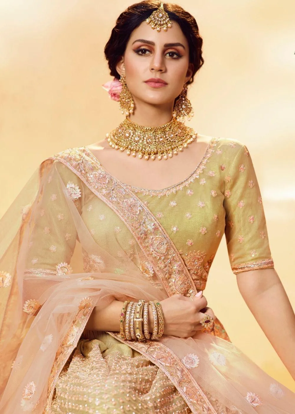 Golden Silk and Soft Net Bridal Lehenga Choli with Resham Embroidery and Aari work